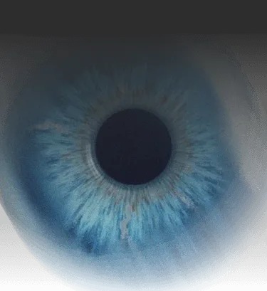 Close-up image of a human eye with a vibrant blue iris and dilated pupil, conveying a sense of curiosity and intensity.